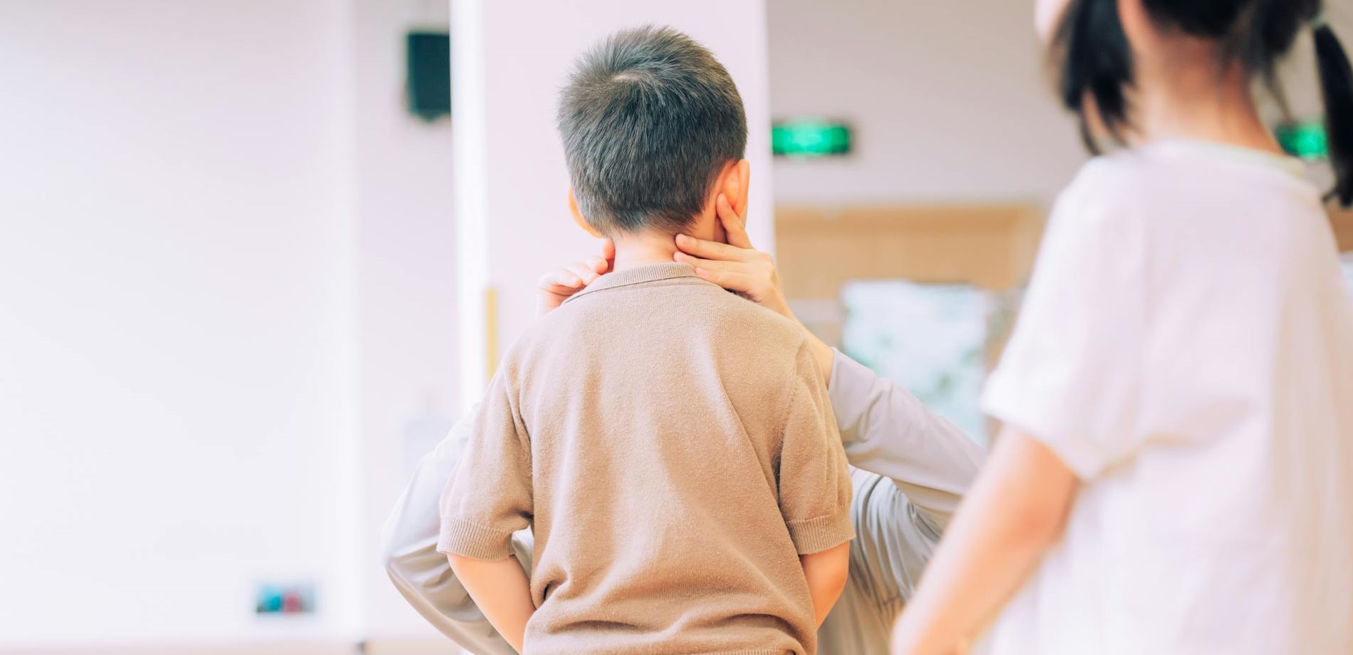 A doctor examining a child in a hospital setting